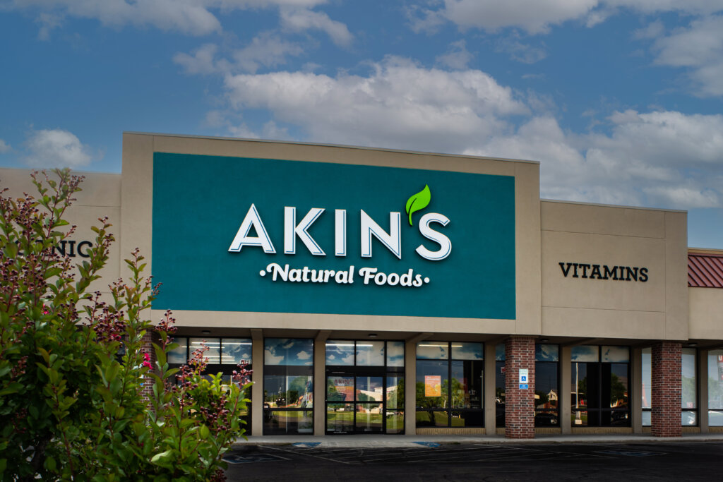 Front entrance of an Akins Natural Foods grocery store building architecture by SGA Design Group.